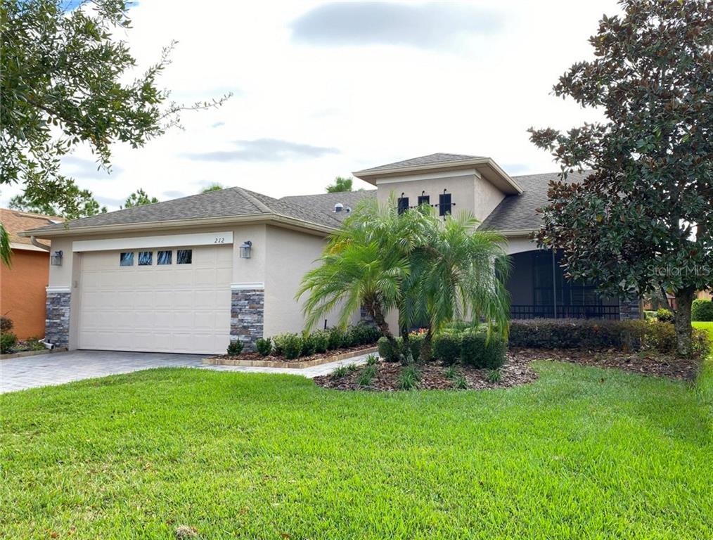 212 Scripps Ranch Road Poinciana, FL 34759 - Photo 1 of 1 a view of a house with a yard and plants