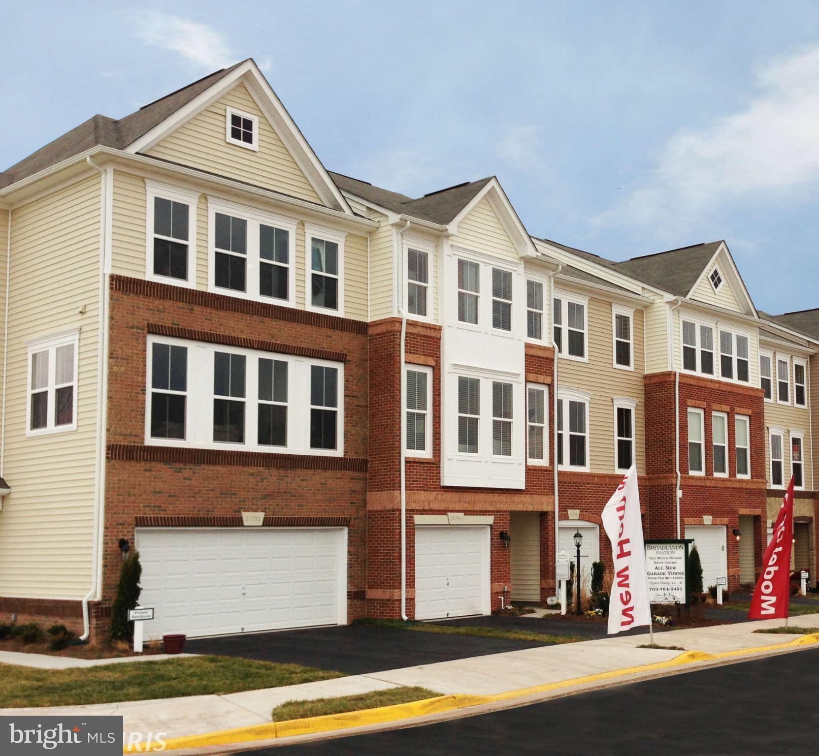 a front view of a residential apartment building with a yard