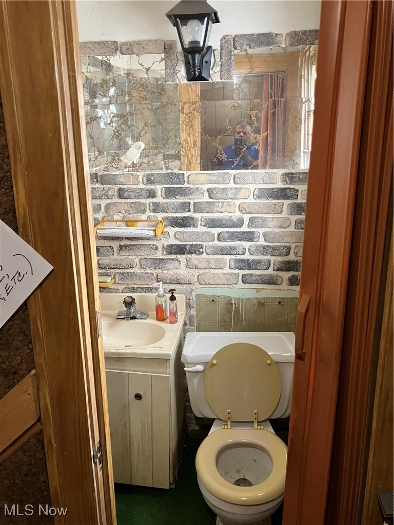 1058 Pembrook Road Cleveland Heights, OH 44121 - Photo 10 of 39 Bathroom with vanity and brick wall