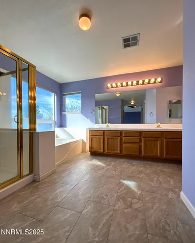 a large bathroom with a large tub and double vanity