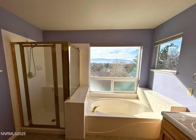 a bathroom with a bathtub and a window