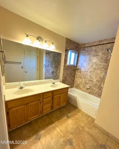 a spacious bathroom with a tub a sink and a large mirror