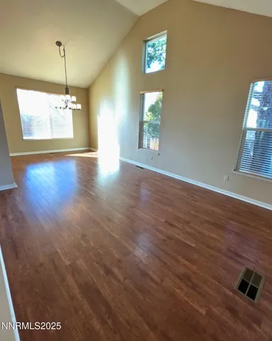 a view of a room with wooden floor and windows