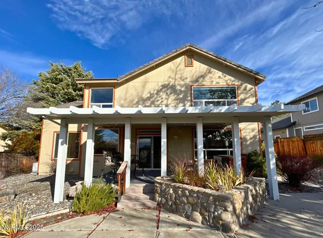 a view of a house with outdoor seating