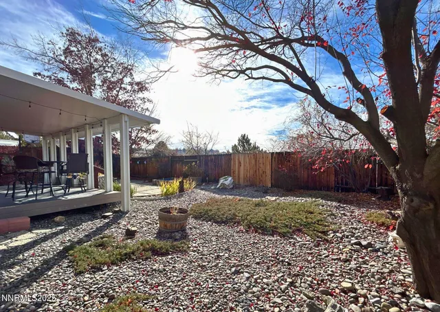 a view of a backyard with sitting area