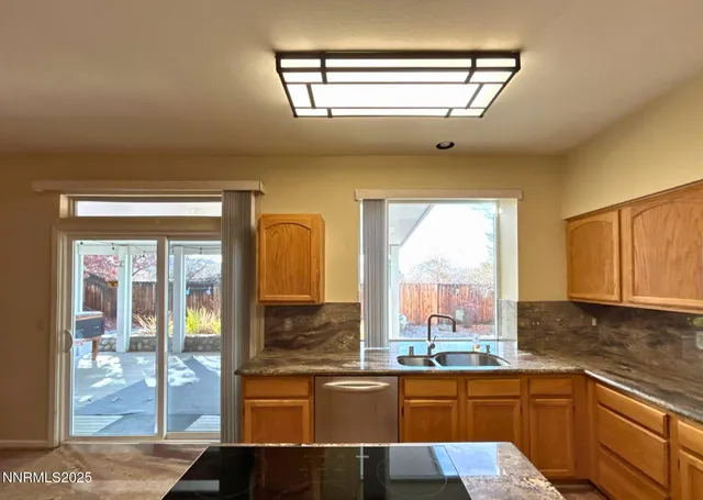 a open kitchen with stainless steel appliances granite countertop a sink and cabinets