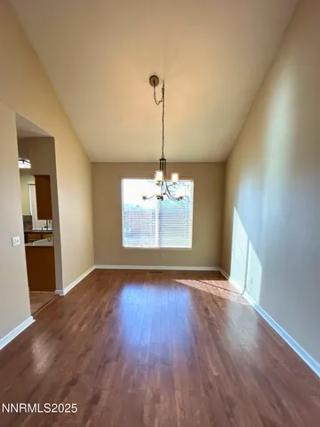 a view of a room with window wooden floor and kitchen view