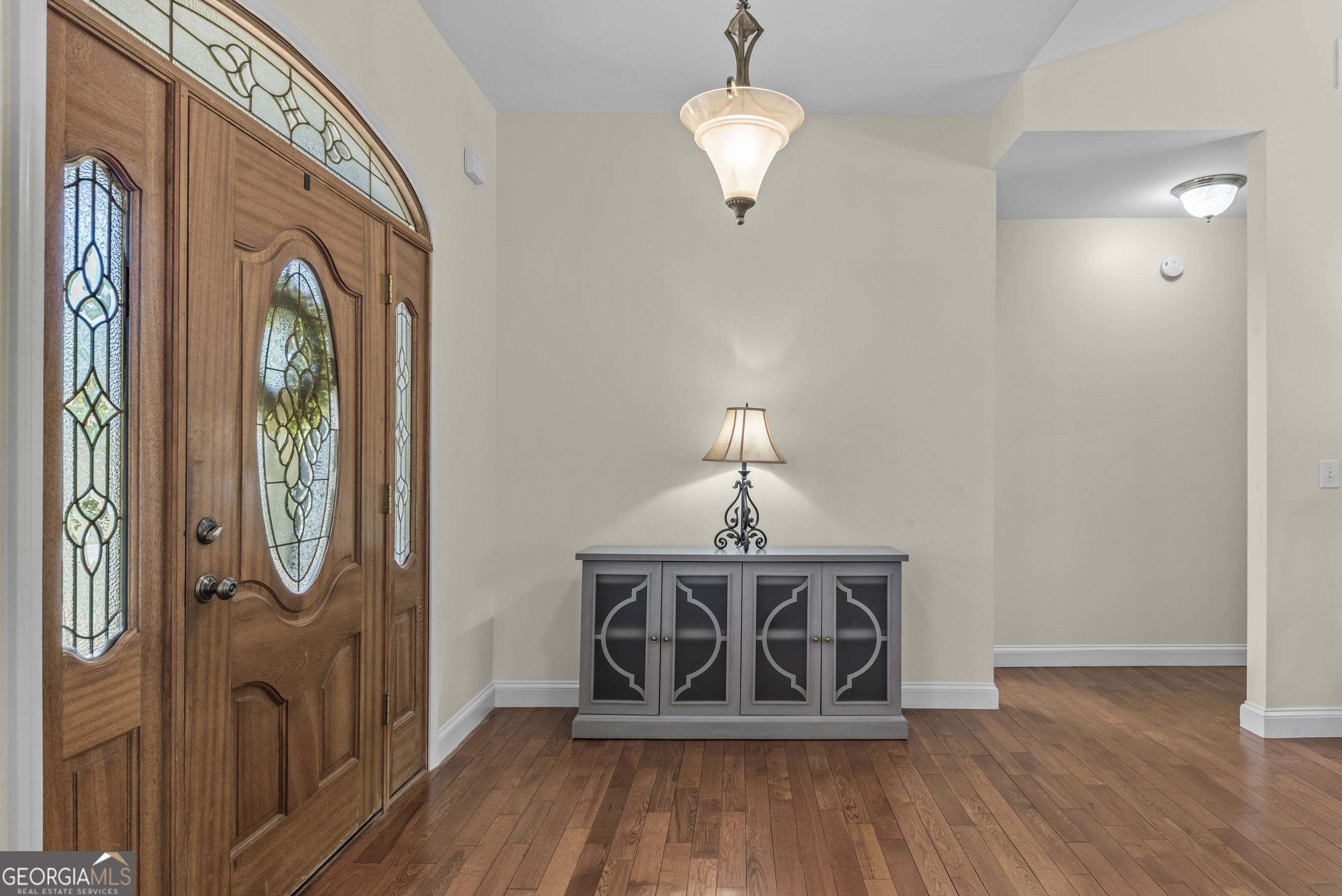 180 Cooper Road Social Circle, GA 30025 - Photo 13 of 51 a view of a livingroom with wooden floor and staircase