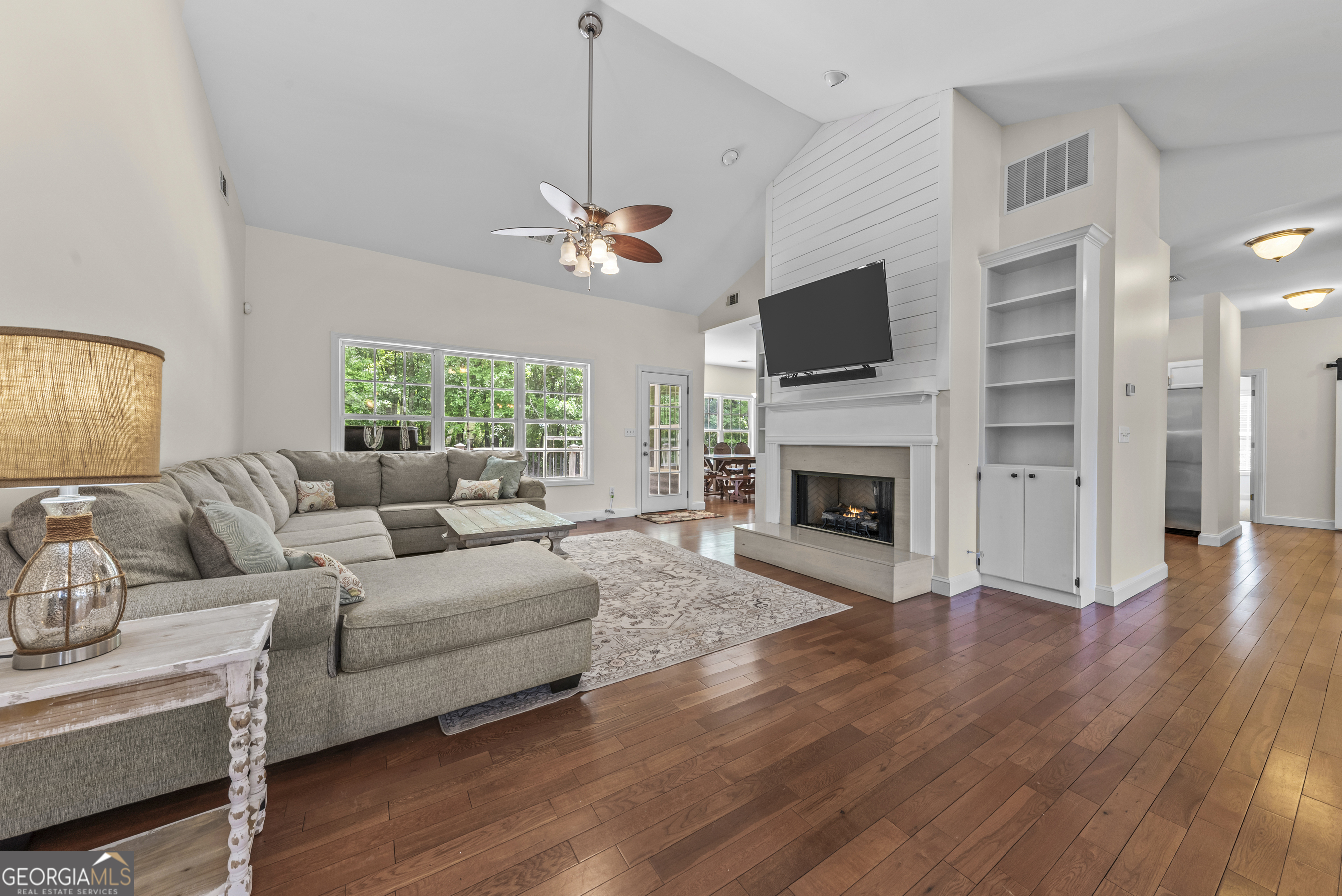 180 Cooper Road Social Circle, GA 30025 - Photo 15 of 51 a living room with furniture a flat screen tv and a fireplace
