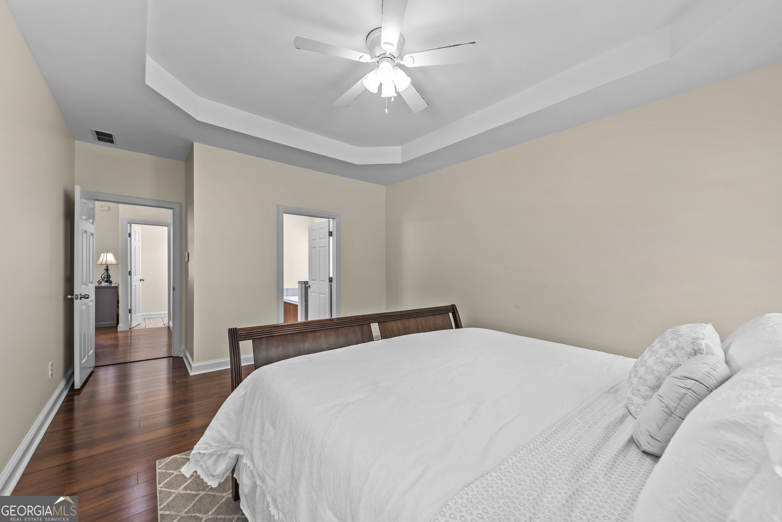180 Cooper Road Social Circle, GA 30025 - Photo 30 of 51 a bedroom with a bed and a chandelier