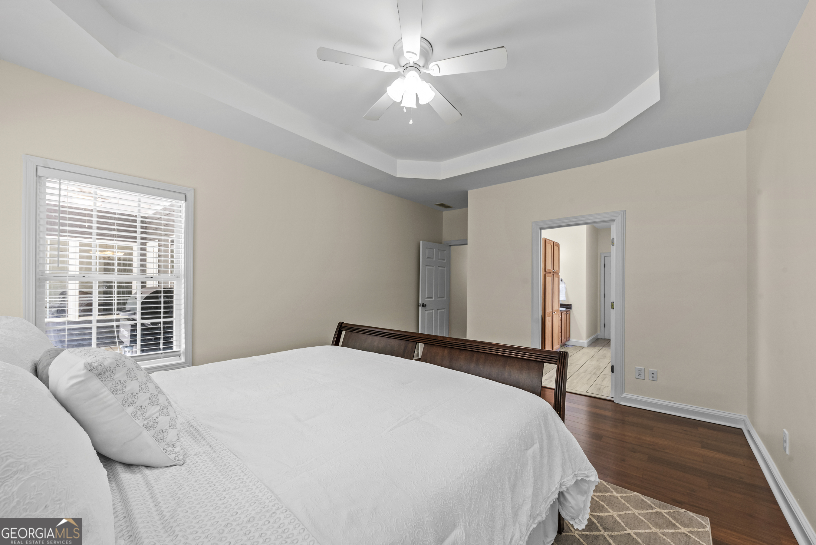 180 Cooper Road Social Circle, GA 30025 - Photo 31 of 51 a bedroom with a large bed and a chandelier