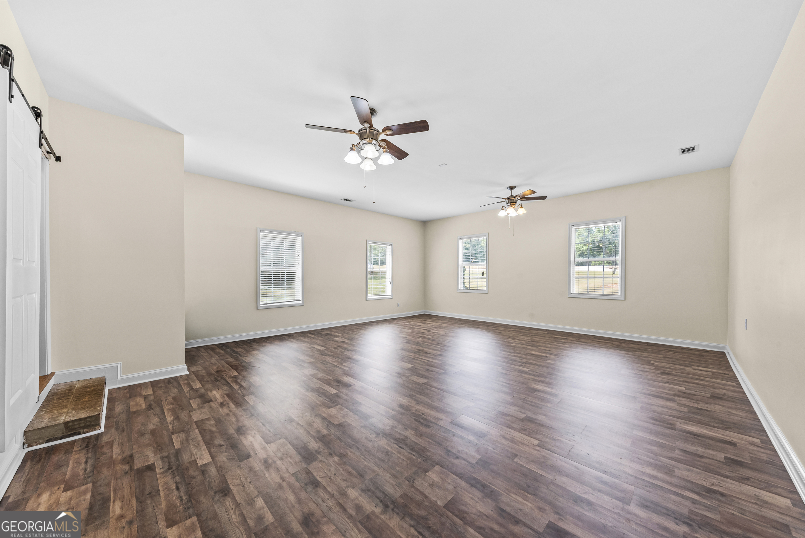 180 Cooper Road Social Circle, GA 30025 - Photo 44 of 51 a view of an empty room with a window and wooden floor