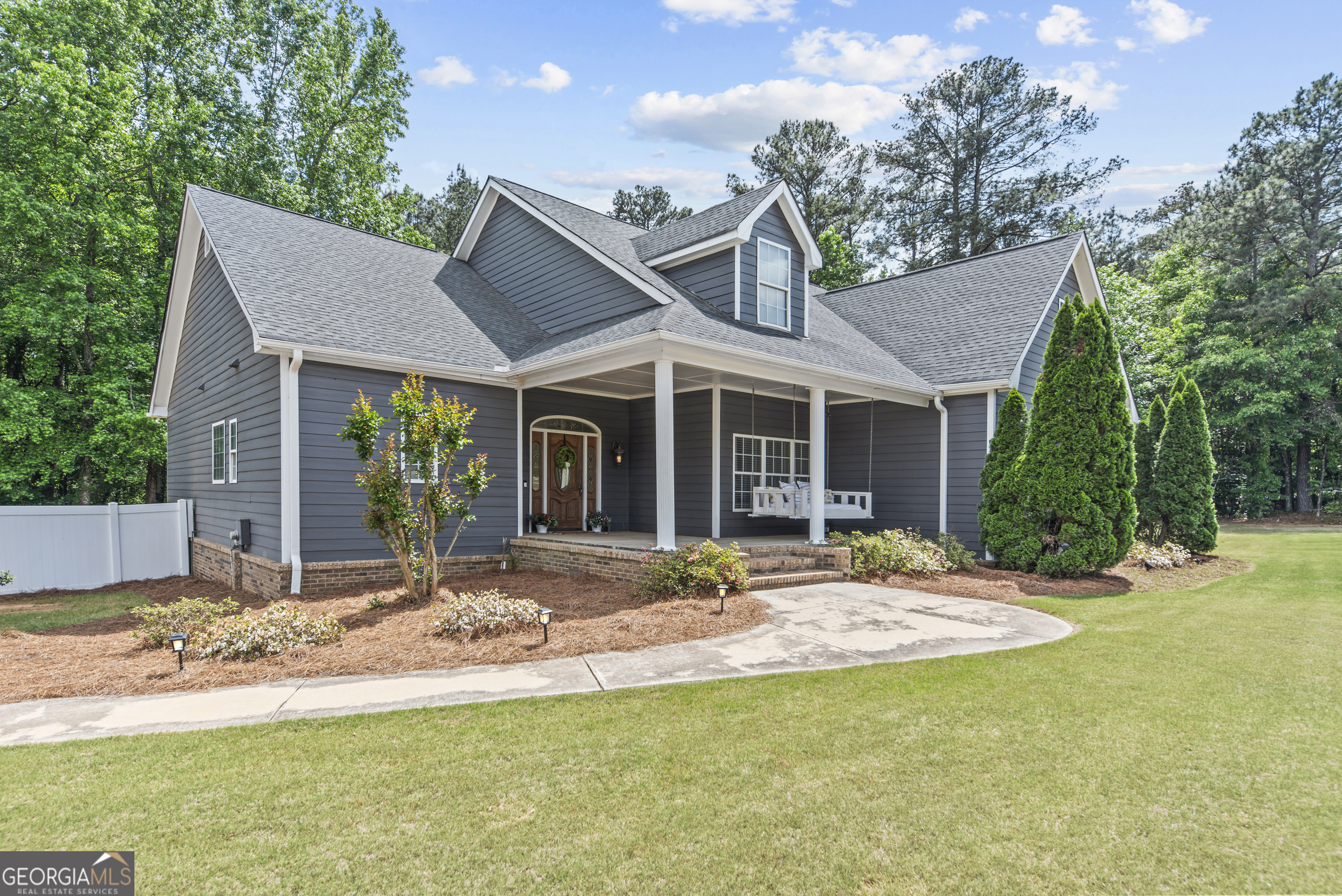 180 Cooper Road Social Circle, GA 30025 - Photo 9 of 51 a view of a house with a yard and sitting area
