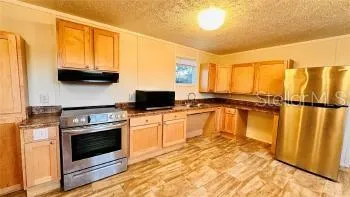 a kitchen with a stove a sink and a microwave