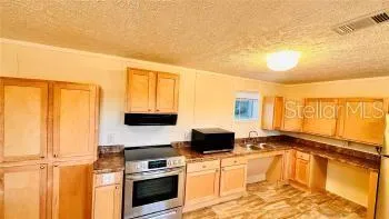 a kitchen with stainless steel appliances a stove a sink and a microwave