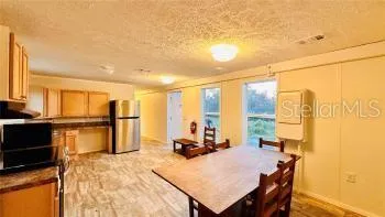 a room with a bed a table and chairs