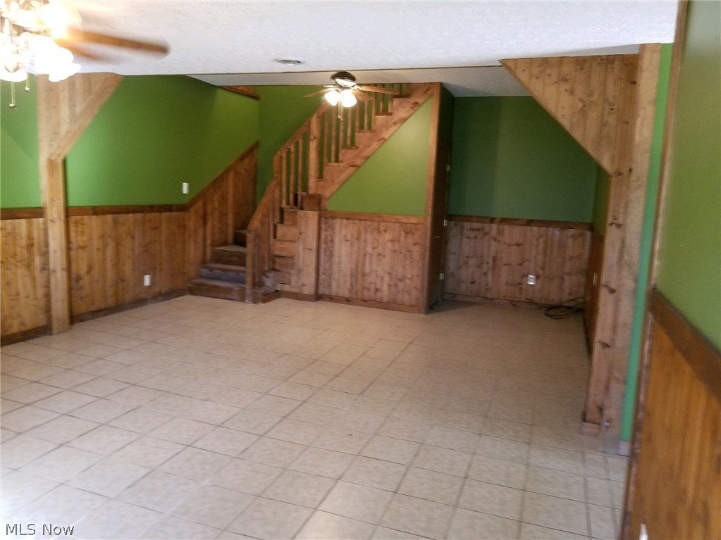 29 Fall Run Road Walker, WV 26180 - Photo 26 of 35 Great room features 2 ceiling fans with lights, ceramic tile, and wood burning fireplace