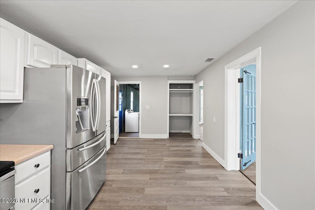 242 Taylor Fury Road Pomona Park, FL 32181 - Photo 12 of 40 a view of a kitchen with a refrigerator and a stove