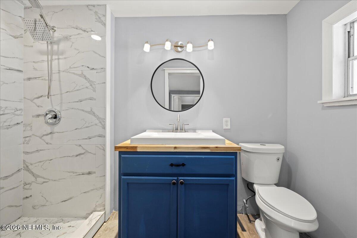 242 Taylor Fury Road Pomona Park, FL 32181 - Photo 17 of 40 a bathroom with a sink a toilet and a mirror