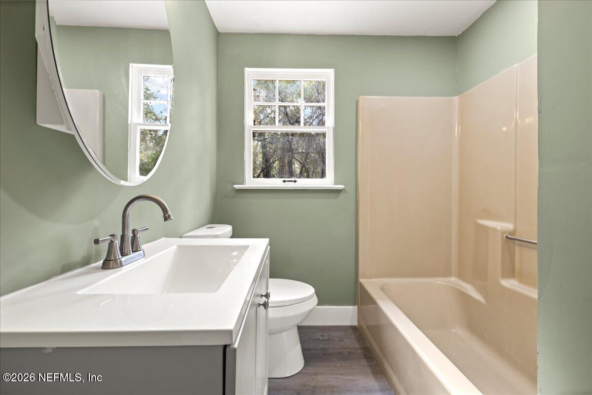 242 Taylor Fury Road Pomona Park, FL 32181 - Photo 18 of 40 a bathroom with a sink a toilet and a bathtub