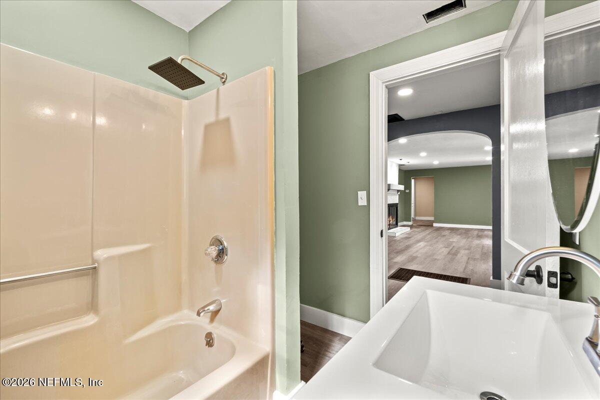 242 Taylor Fury Road Pomona Park, FL 32181 - Photo 19 of 40 a bathroom with a tub sink and mirror