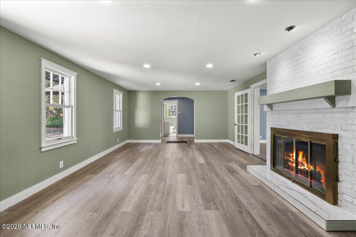 242 Taylor Fury Road Pomona Park, FL 32181 - Photo 2 of 40 a view of an empty room with wooden floor fireplace and a window