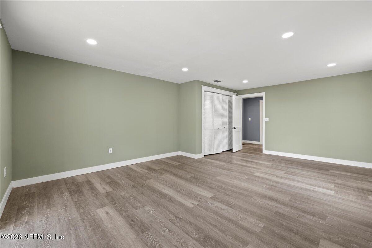 242 Taylor Fury Road Pomona Park, FL 32181 - Photo 22 of 45 a view of an empty room with wooden floor