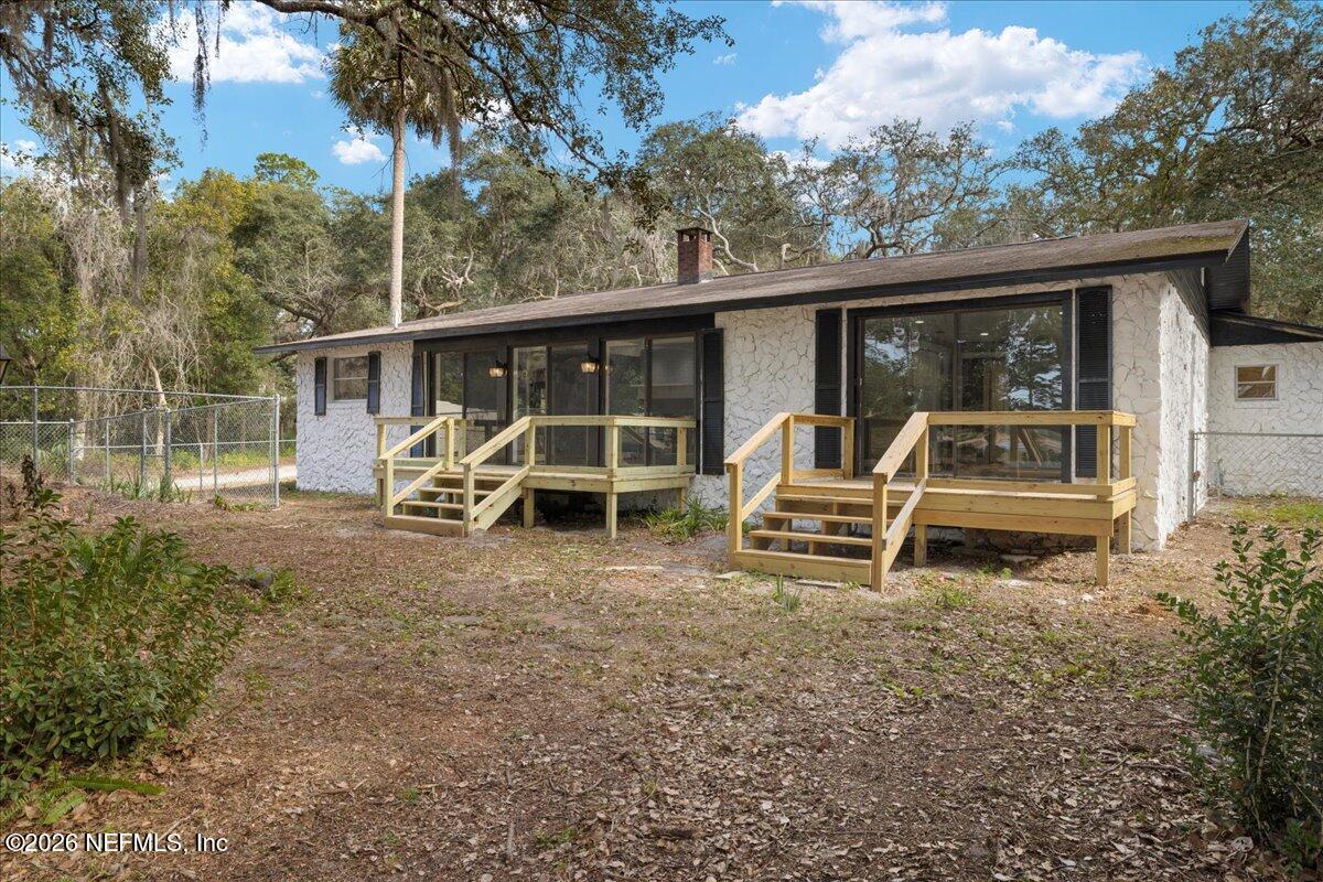 242 Taylor Fury Road Pomona Park, FL 32181 - Photo 28 of 40 a front view of a house with a yard table and chairs