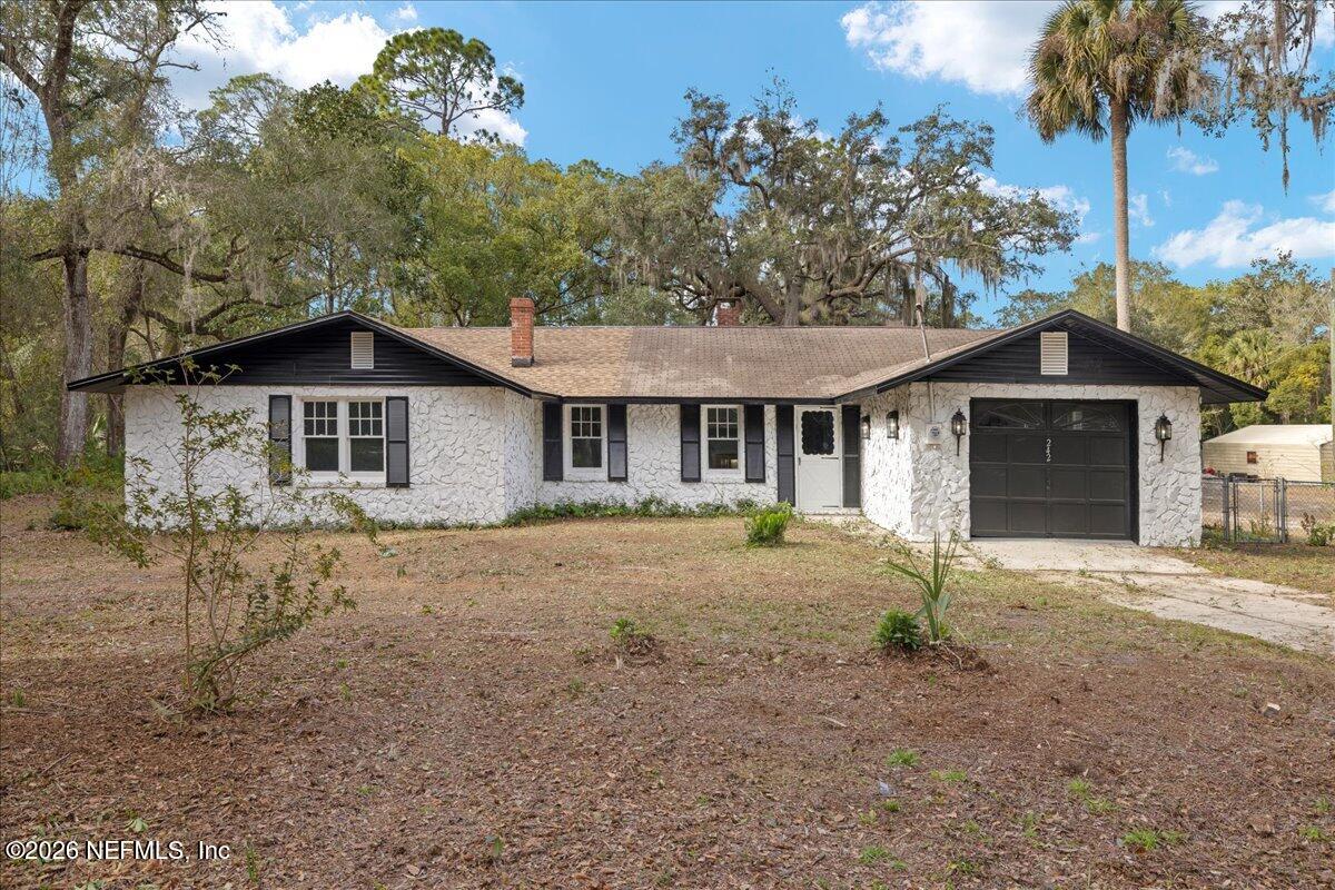 242 Taylor Fury Road Pomona Park, FL 32181 - Photo 36 of 40 a view of a yard in front of a house with a large tree