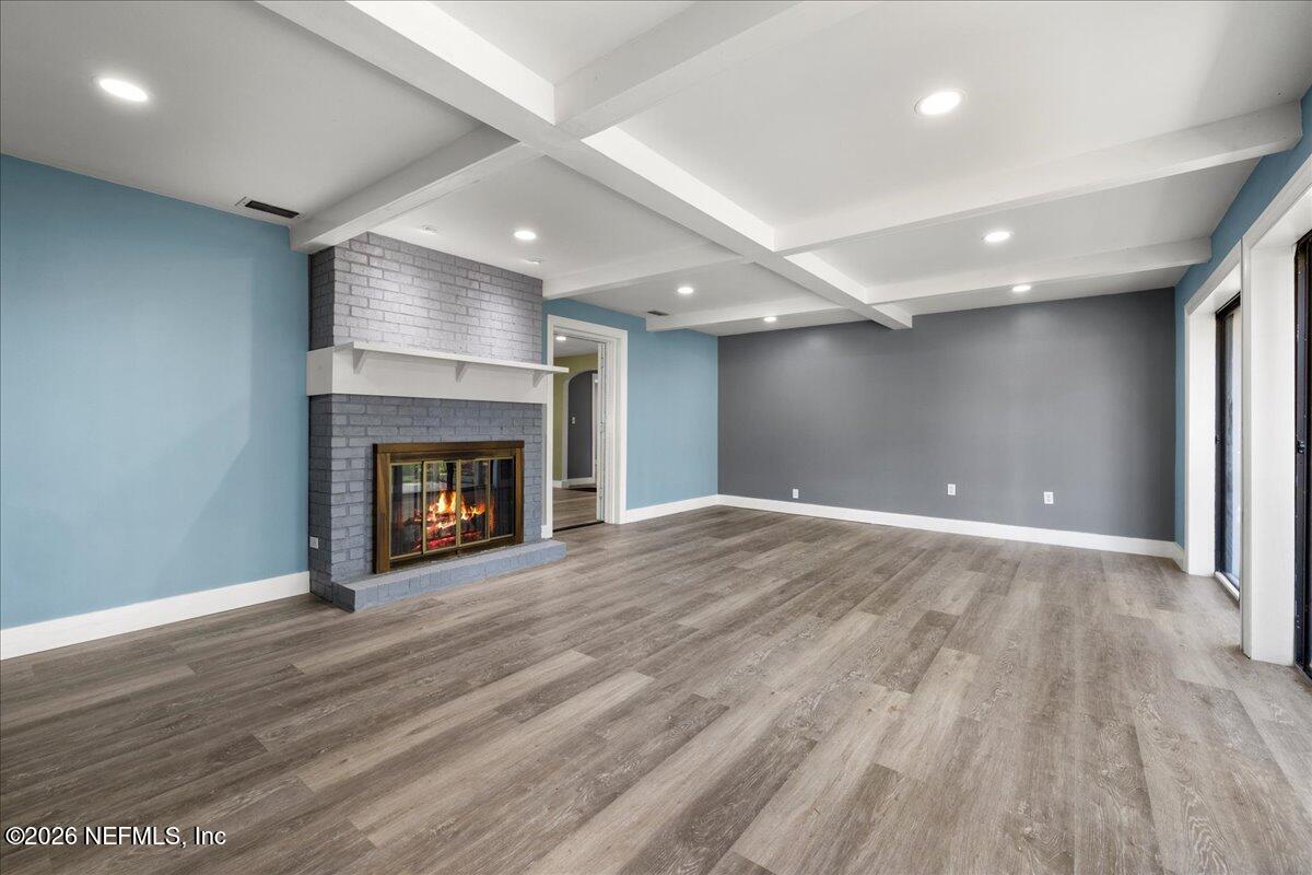 242 Taylor Fury Road Pomona Park, FL 32181 - Photo 10 of 45 a view of an empty room with wooden floor fireplace and a window