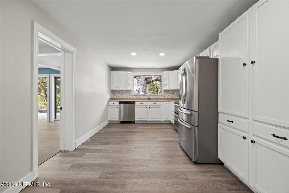 242 Taylor Fury Road Pomona Park, FL 32181 - Photo 10 of 40 a kitchen with cabinets and stainless steel appliances