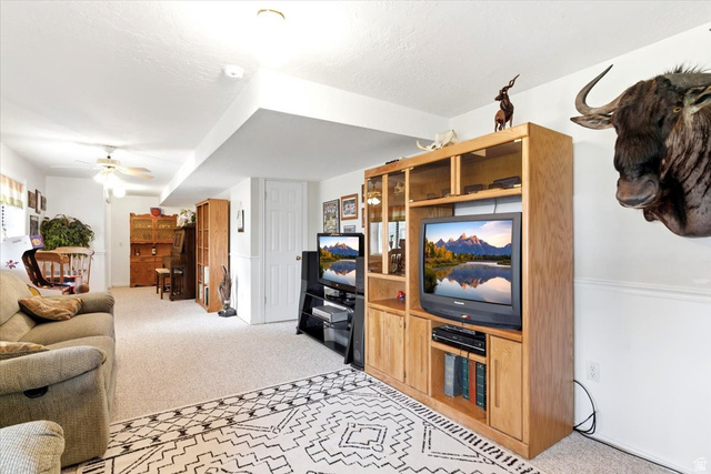 5321 South 3100th Street West Roy, UT 84067 - Photo 34 of 64 Spacious room featuring neutral carpeting, recessed lighting, and a built-in entertainment center with wood-finish cabinetry