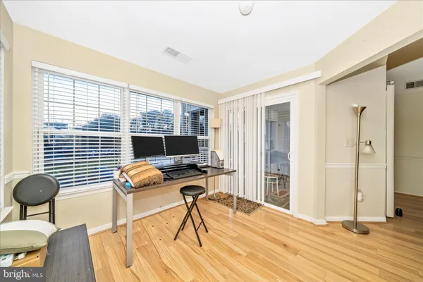 a view of a workspace with furniture and a window