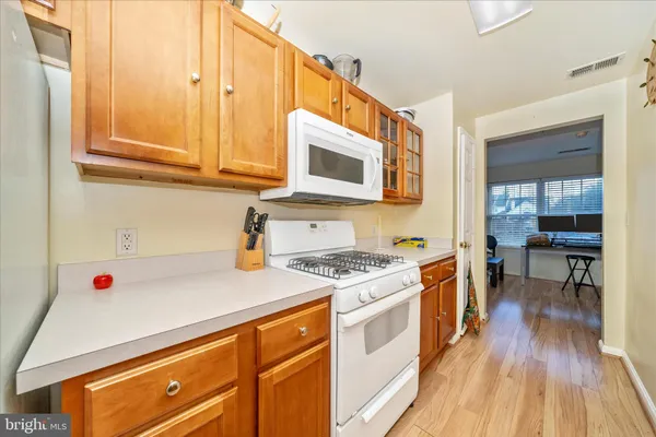 a kitchen with stainless steel appliances granite countertop a stove and a microwave
