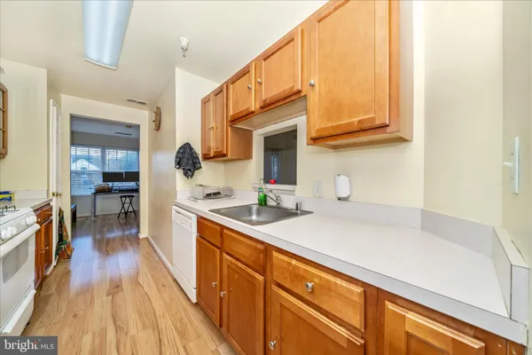 a kitchen with stainless steel appliances a sink a stove and cabinets