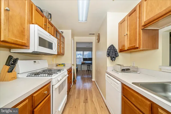 a kitchen with stainless steel appliances granite countertop a sink and cabinets