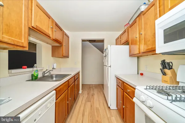 a kitchen with stainless steel appliances a stove a sink and a refrigerator