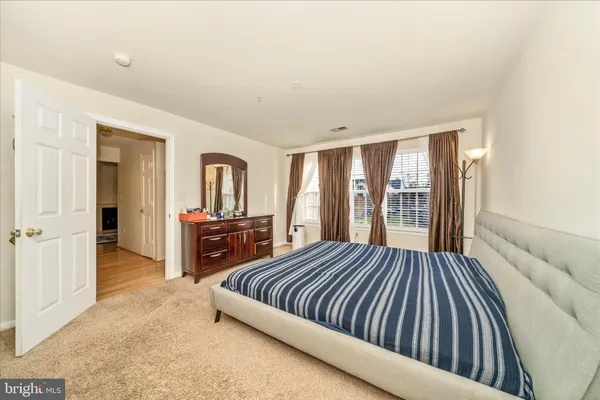 a bedroom with a large bed and a dresser