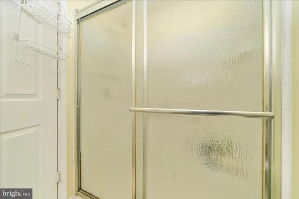 a bathroom with a glass shower door
