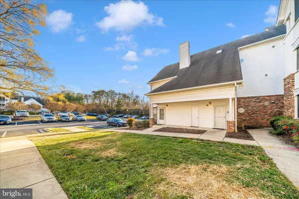 a view of a house with a yard and a patio