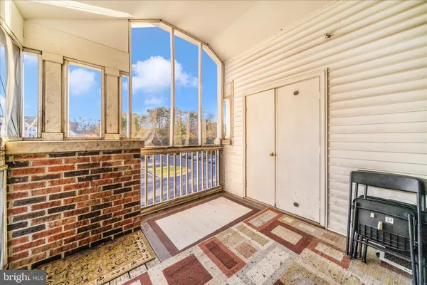a view of a hallway with two windows