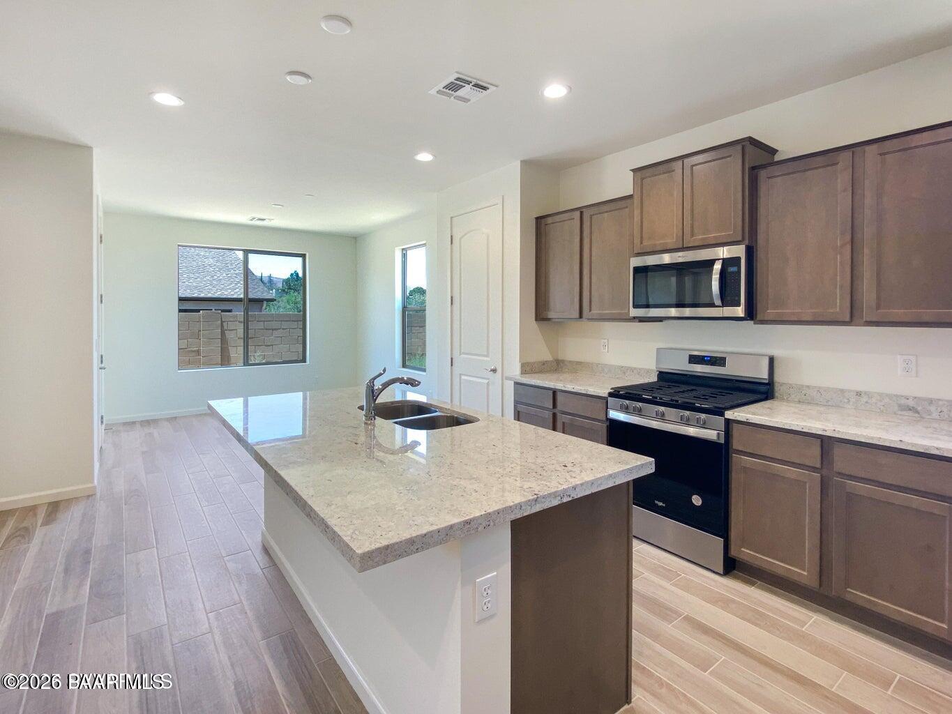832 Eugene Road Clarkdale, AZ 86324 - Photo 6 of 30 a kitchen with a sink a microwave a stove and refrigerator