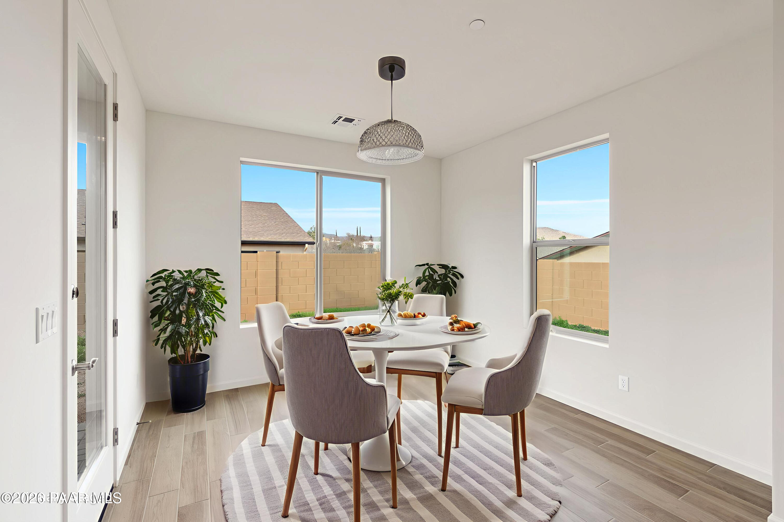 832 Eugene Road Clarkdale, AZ 86324 - Photo 8 of 30 a dining room with furniture potted plants and wooden floor