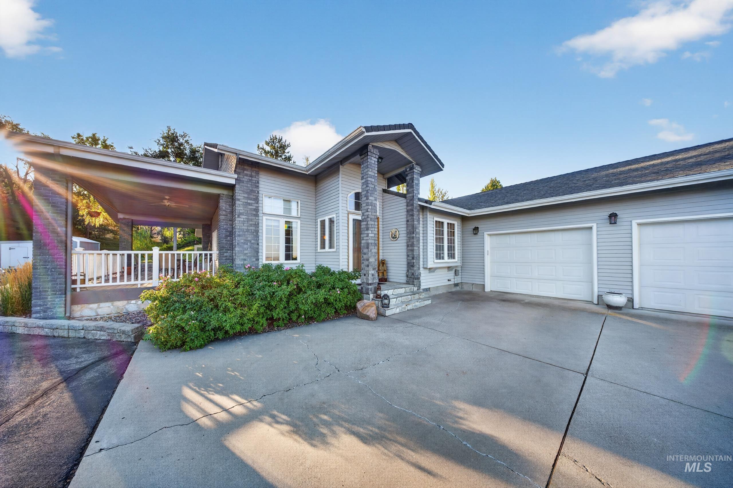 5540 Finley Road Fruitland, ID 83619 - Photo 20 of 50 Siding exterior with stone accents, covered entry, attached two-car garage, and a concrete driveway