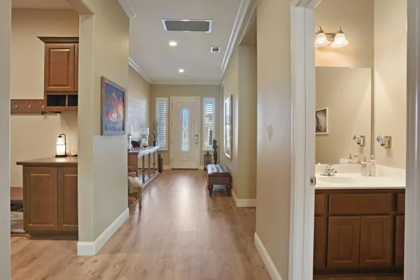 a view of a hallway with wooden floor windows and livingroom view