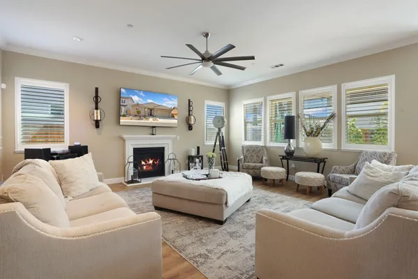 a living room with furniture a large window and a fireplace