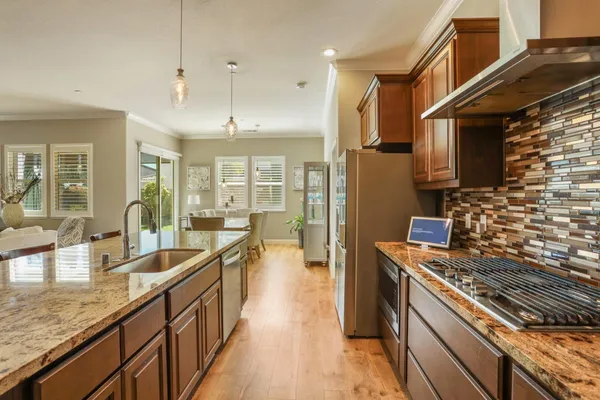 a kitchen with sink stove and cabinets