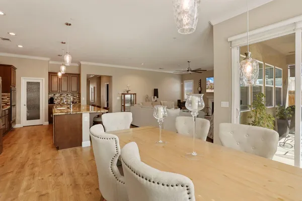 a large white kitchen with a large window and stainless steel appliances