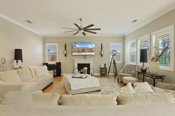 a living room with furniture a large window and a fireplace