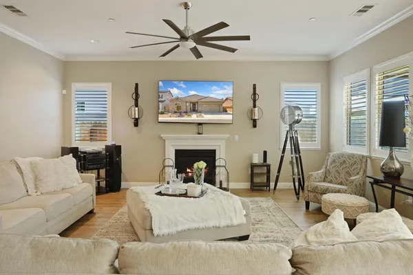 a living room with furniture a fireplace and a flat screen tv